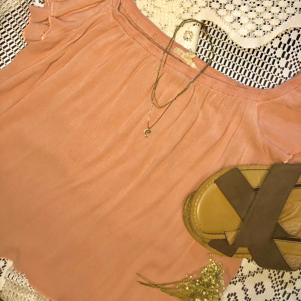 This is a light pink sheer shirt